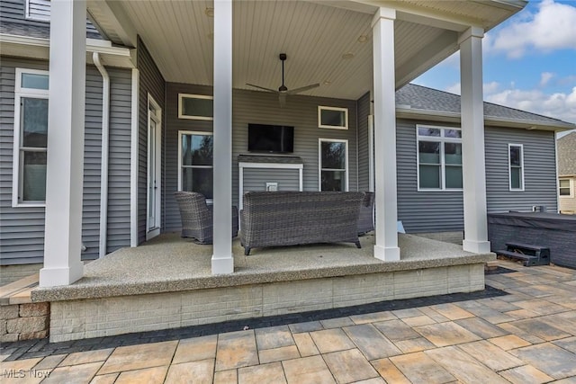 view of patio featuring covered porch and a hot tub