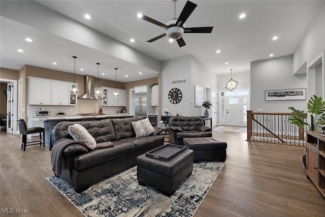 living room with recessed lighting, wood finished floors, visible vents, and ceiling fan