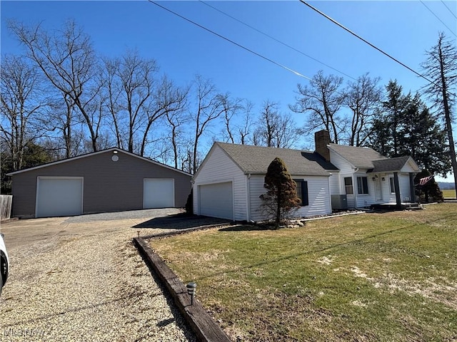 view of front facade featuring a front lawn, a chimney, and a garage