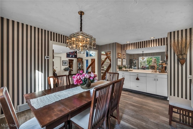 dining space featuring a notable chandelier, recessed lighting, wallpapered walls, and dark wood-type flooring