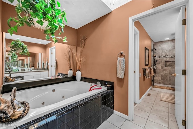 full bathroom with tile patterned floors, a jetted tub, baseboards, and a stall shower