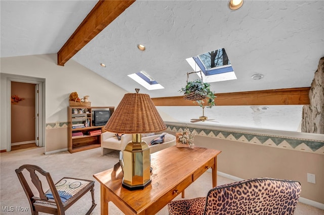 sitting room featuring lofted ceiling with skylight, light carpet, and baseboards