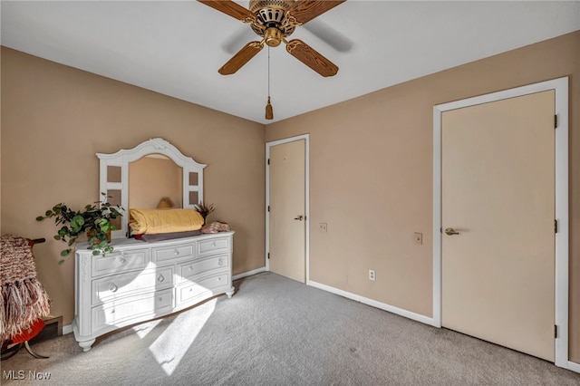 unfurnished bedroom featuring light carpet, ceiling fan, and baseboards