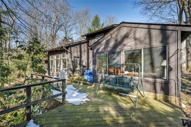 rear view of house featuring a deck and a chimney