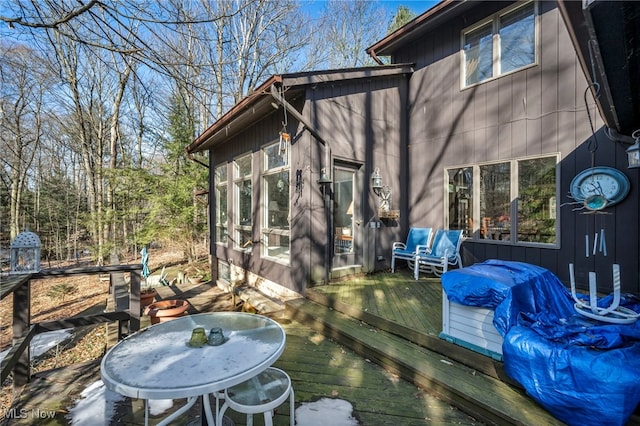 wooden deck featuring a sunroom