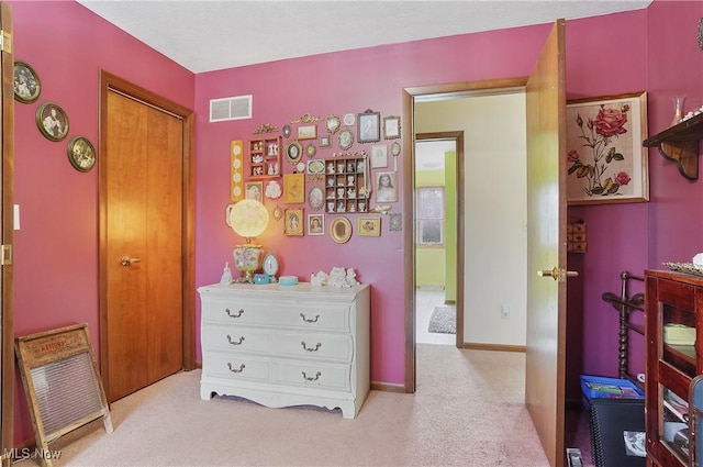 carpeted bedroom with baseboards and visible vents