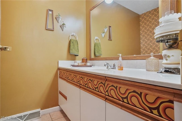 bathroom featuring tile patterned flooring, visible vents, vanity, and baseboards