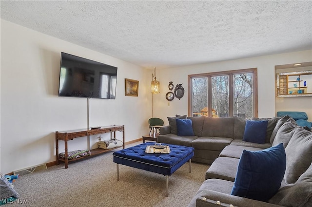 carpeted living area featuring a textured ceiling and baseboards