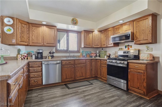 kitchen featuring a sink, brown cabinetry, and stainless steel appliances