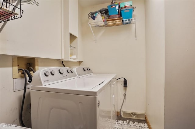 clothes washing area featuring laundry area, baseboards, and independent washer and dryer