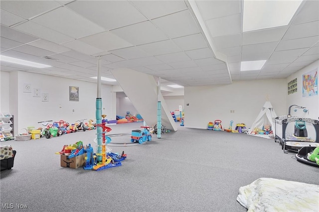 game room with a paneled ceiling