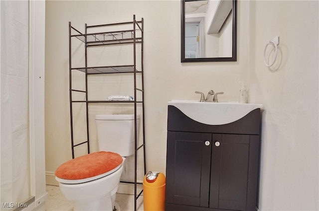 bathroom with tile patterned floors, toilet, and vanity