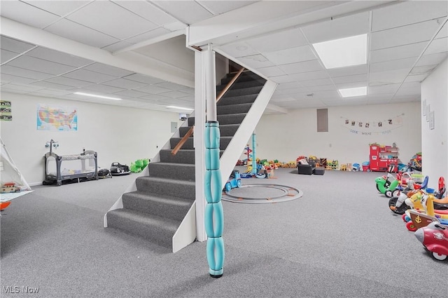 rec room with a drop ceiling and carpet flooring