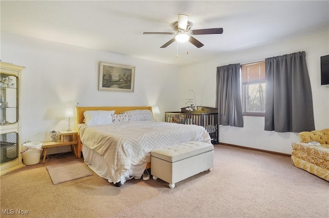 carpeted bedroom with baseboards and ceiling fan