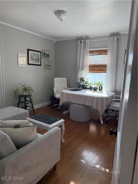 sitting room featuring baseboards, ornamental molding, and hardwood / wood-style flooring