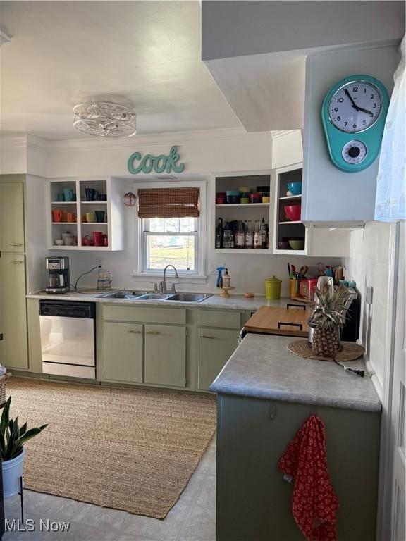 kitchen with open shelves, a sink, stainless steel dishwasher, light countertops, and green cabinetry