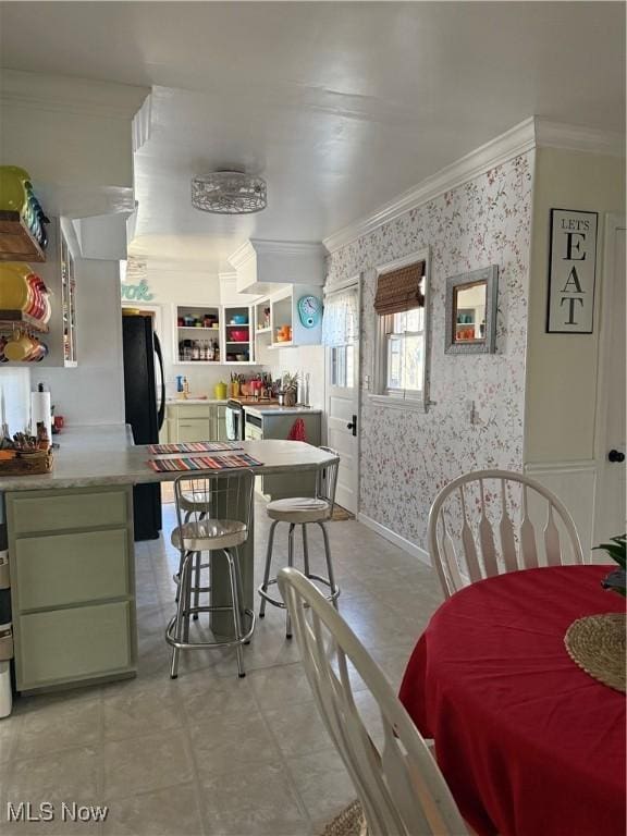 dining space with wallpapered walls, crown molding, and baseboards