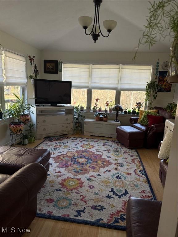 living area with a chandelier and wood finished floors