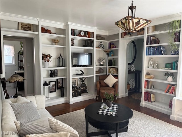 sitting room with wood finished floors and crown molding