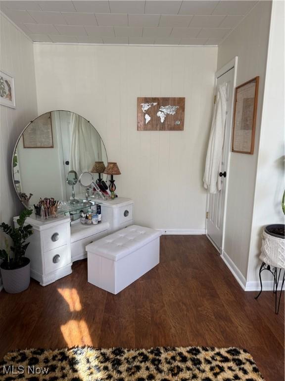 interior space with baseboards and dark wood-style flooring