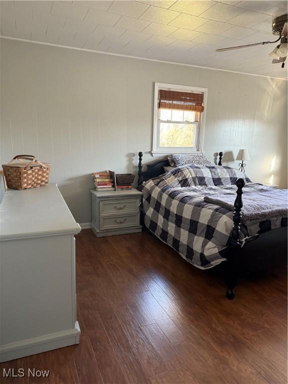 bedroom featuring ceiling fan and dark wood-style floors