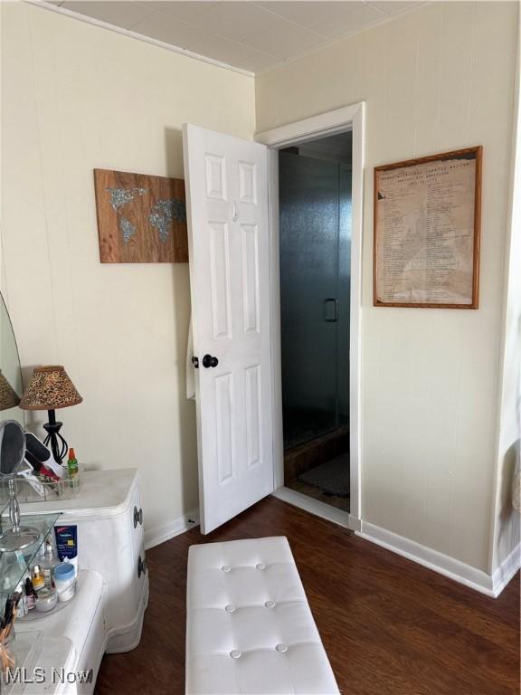 interior space with baseboards and wood finished floors