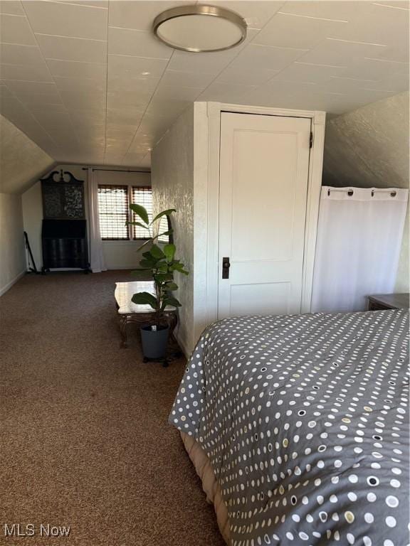 bedroom with vaulted ceiling and carpet flooring