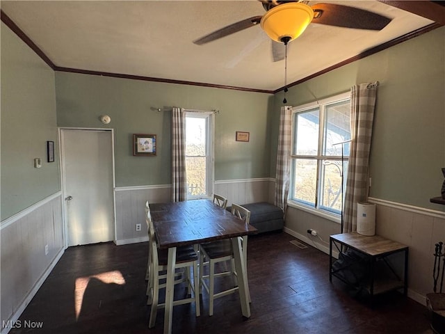 dining room with visible vents, a wealth of natural light, and wainscoting