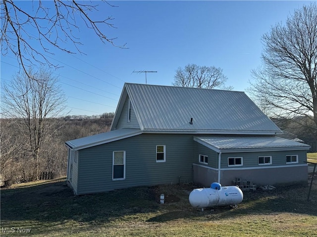 rear view of property featuring metal roof