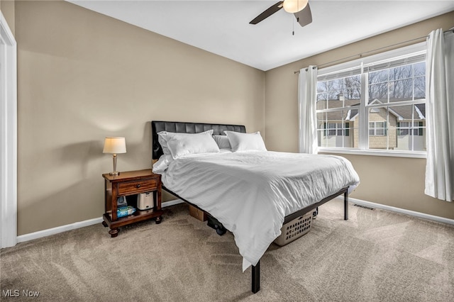 carpeted bedroom featuring visible vents, baseboards, and ceiling fan