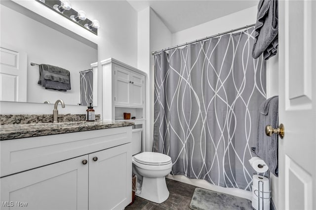 bathroom with toilet, shower / tub combo with curtain, and vanity