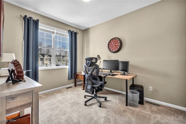 carpeted office space featuring visible vents and baseboards