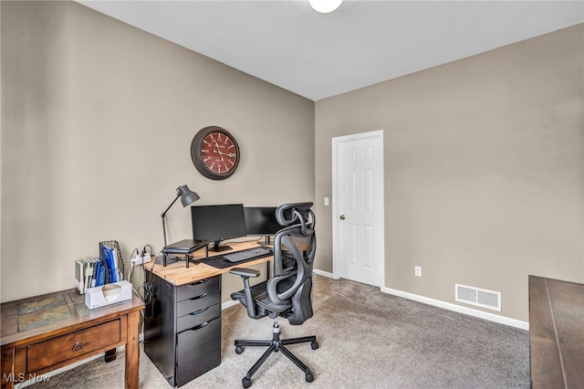 carpeted office space with visible vents and baseboards