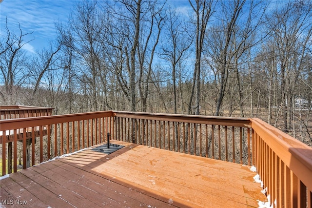 wooden deck with a forest view