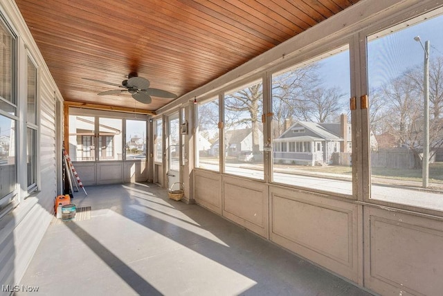 unfurnished sunroom featuring a ceiling fan