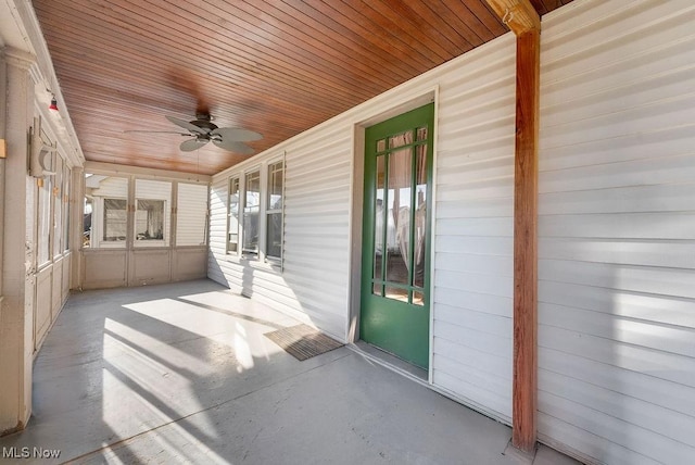 unfurnished sunroom with ceiling fan and wooden ceiling