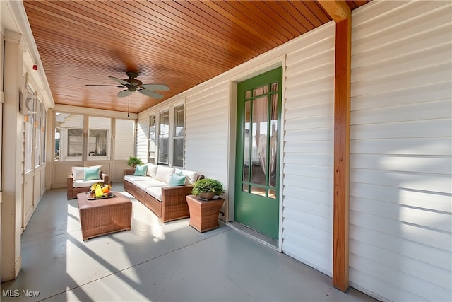 sunroom / solarium featuring wood ceiling and a ceiling fan