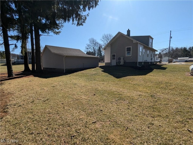 view of side of property featuring a lawn and a chimney