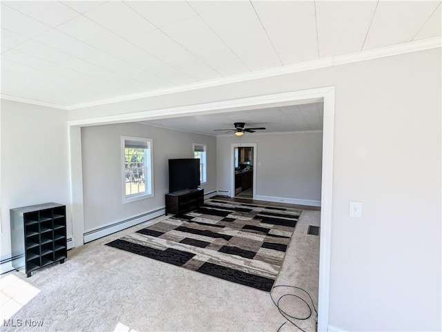 living area featuring a baseboard heating unit, carpet flooring, crown molding, a baseboard radiator, and baseboards