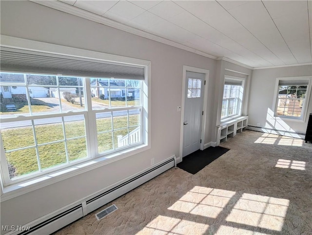 foyer with a baseboard heating unit, carpet floors, crown molding, a baseboard radiator, and baseboards