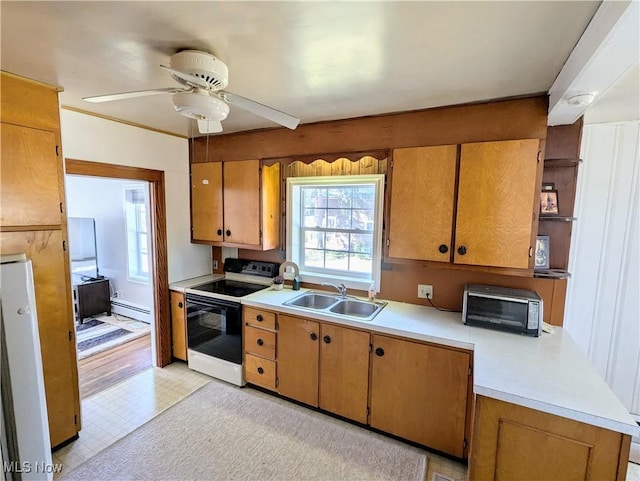 kitchen with a sink, a baseboard heating unit, range with electric stovetop, a toaster, and light countertops