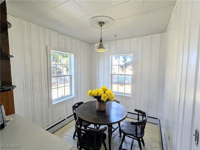 dining room with a baseboard radiator and light floors