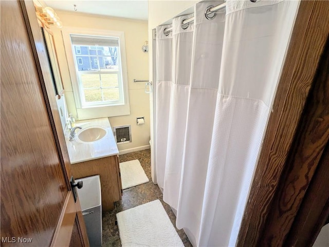 bathroom with visible vents, a shower with curtain, toilet, baseboards, and vanity