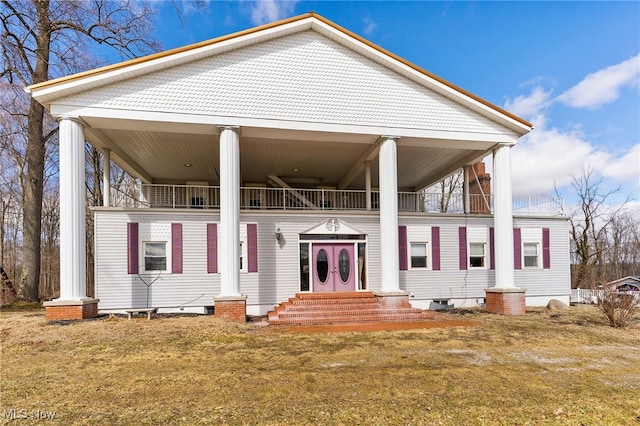 neoclassical / greek revival house featuring entry steps and a balcony