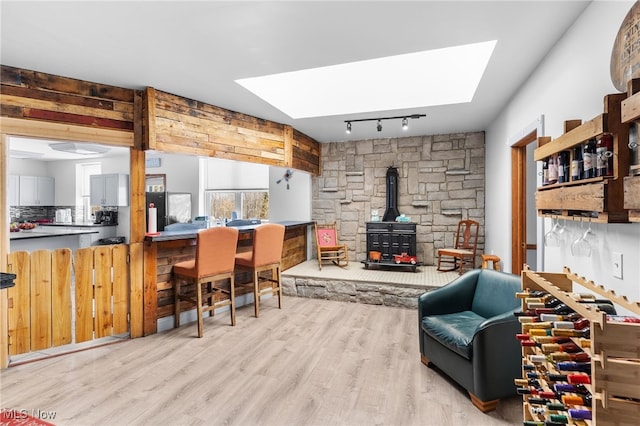 interior space featuring a wood stove, a skylight, and wood finished floors