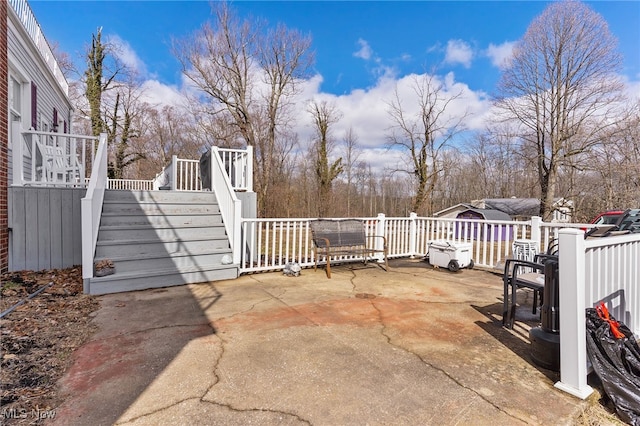 view of patio featuring a deck and stairs