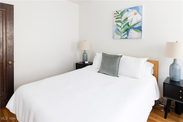 bedroom featuring wood finished floors