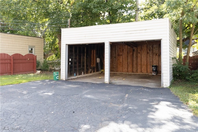 detached garage featuring fence