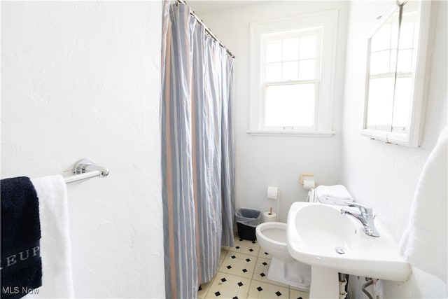 bathroom featuring a sink and a shower with curtain