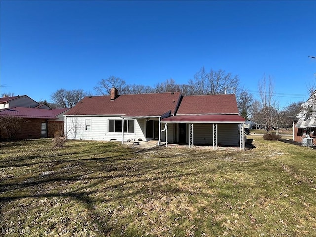 rear view of property featuring a lawn and a chimney